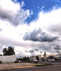 Street by buildings against sky