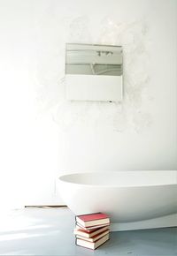 Tranquility represented through literature beside an oblong tub. 