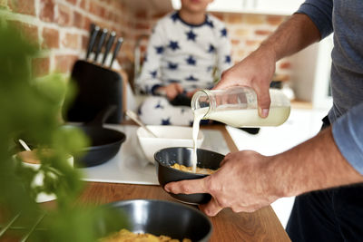 Midsection of man preparing food