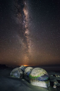 View of rocks against star field at night