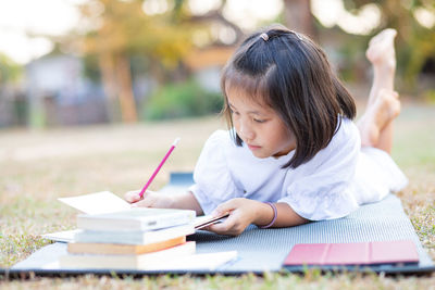 Side view of a woman reading book