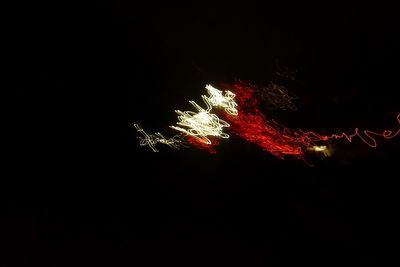 Low angle view of illuminated lights at night