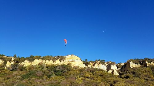 Low angle view of mountain against blue sky