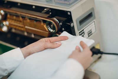 High angle view of woman holding paper