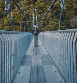 Man standing on footbridge