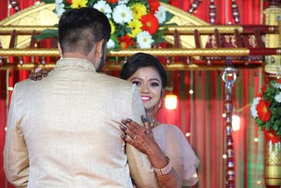 Midsection of couple kissing at temple