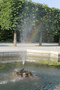 Fountain in park against sky