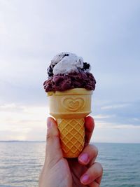 Cropped image of person holding ice cream
