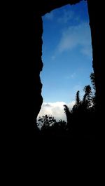 Low angle view of silhouette trees against sky