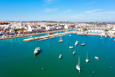 High angle view of cityscape by sea against sky