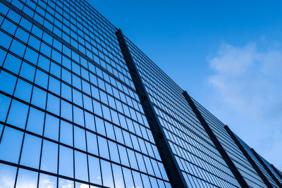 Low angle view of modern building against blue sky