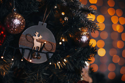 Christmas ball with deer figurine hanging on the christmas tree. magic details 