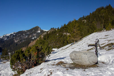 Scenic view of snowcapped mountains against clear blue sky