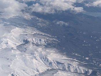 Aerial view of snowcapped mountains against sky