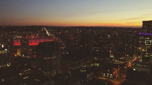 High angle view of illuminated buildings against sky at night