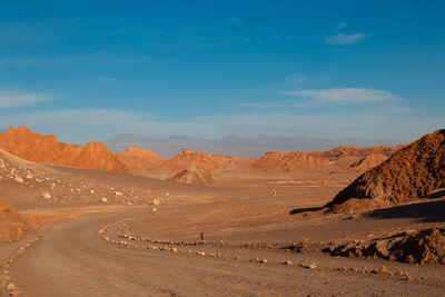 Scenic view of desert road against sky