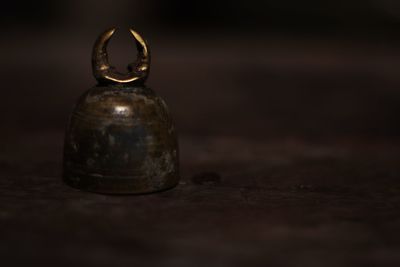 Close-up of old glass container on table