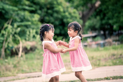 Twin sisters playing at public park