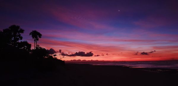 Scenic view of sea against romantic sky at sunset