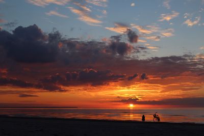 Scenic view of beach against sky during sunset