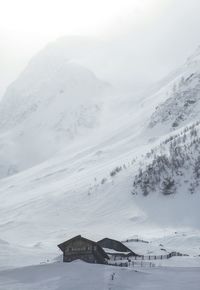 Barn on snow covered landscape