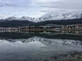 Swan on lake by mountains against sky