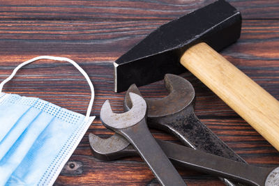 High angle view of work tools on wooden table