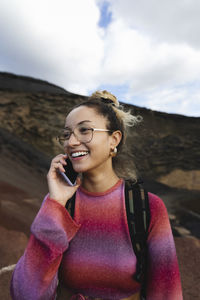 Smiling woman talking on mobile phone