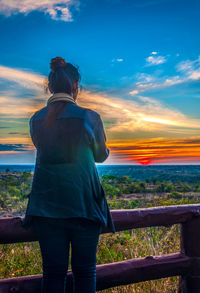 Rear view of woman looking at sunset