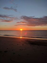 Scenic view of beach against sky during sunset