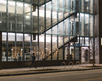 People walking on modern building in city