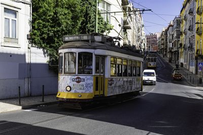 Cars on street against buildings in city