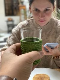 Portrait of a smiling young woman holding drink