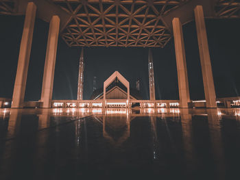 View of bridge over river at night