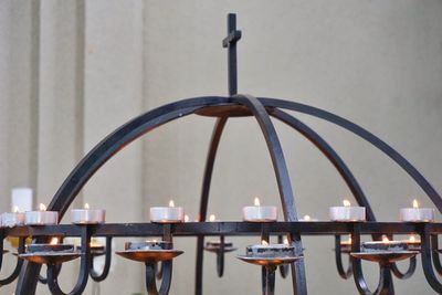 Close-up of cross on candle chandelier