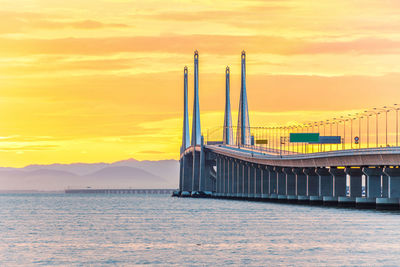 View of bridge over sea during sunset