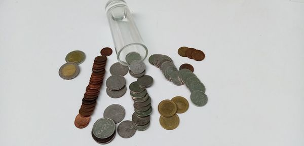 High angle view of coins on white background