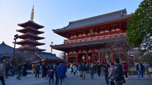 People at temple against clear sky