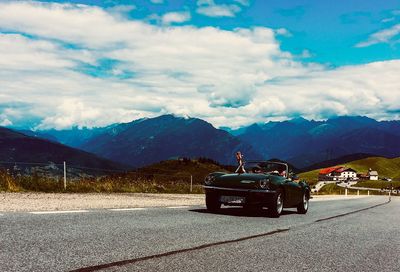 Car on road against mountain range