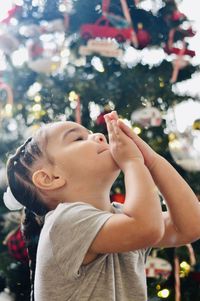 Rear view of boy looking at christmas tree