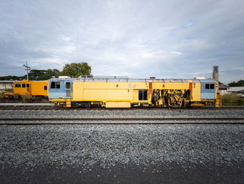 The ballast tamping machine is working to maintain the sleeper and ballast stone.