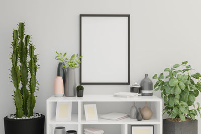 Potted plant on table against wall at home