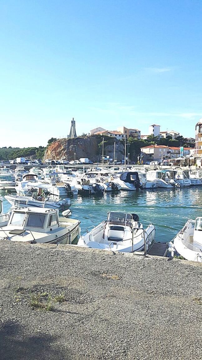 BOATS MOORED ON SEA AGAINST CLEAR SKY