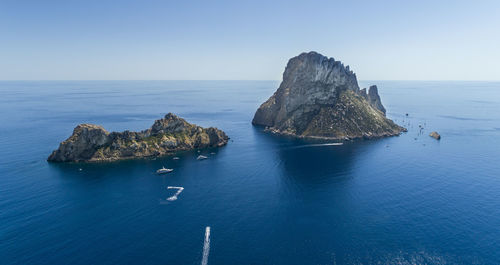 Panoramic view of rock formation in sea against clear sky