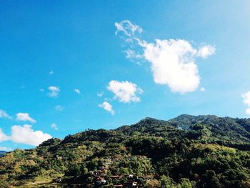 Scenic view of mountains against cloudy sky