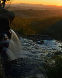 Scenic view of river amidst mountains against sky