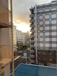 Buildings in city against sky during sunset