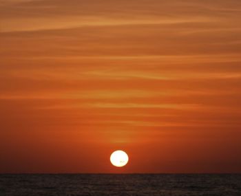 Scenic view of sea against romantic sky at sunset