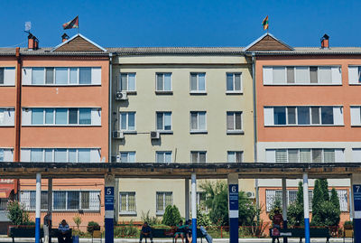 Low angle view of buildings against clear blue sky