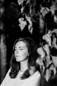 Portrait of young woman looking away outdoors